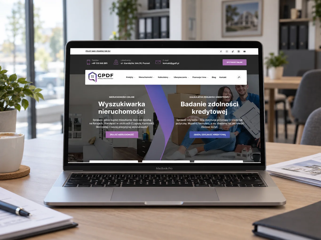 Strona gpdf.pl na laptopie w biurze kredytów i nieruchomości